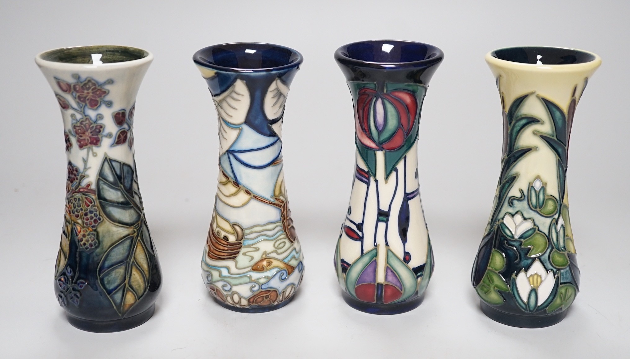 Four boxed small Moorcroft vases, Blackberry, Bulrush, Winds of Change, and a Rennie Macintosh Tribute. Each 11cm high